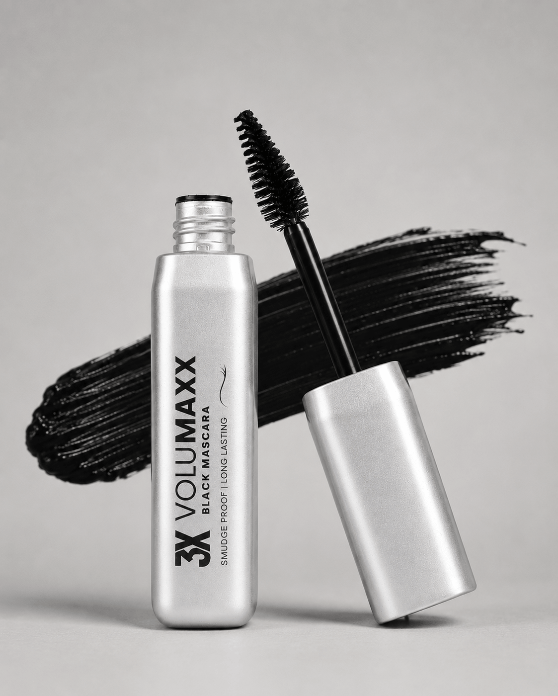 3X Volumaxx mascara bottle with black wand on a gray background volumizing mascara