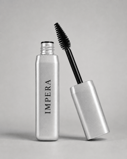 Silver volumizing mascara bottle with black wand on a gray background, featuring the brand 'IMPERA'.