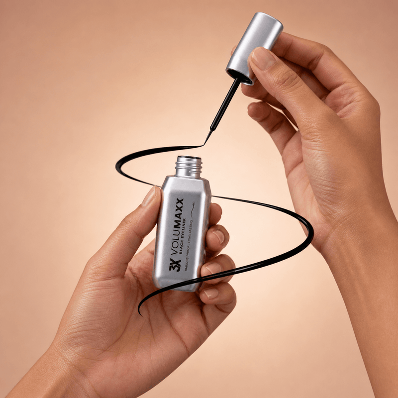 Person applying Volumaxx waterproof liquid eyeliner with a brush on a beige background