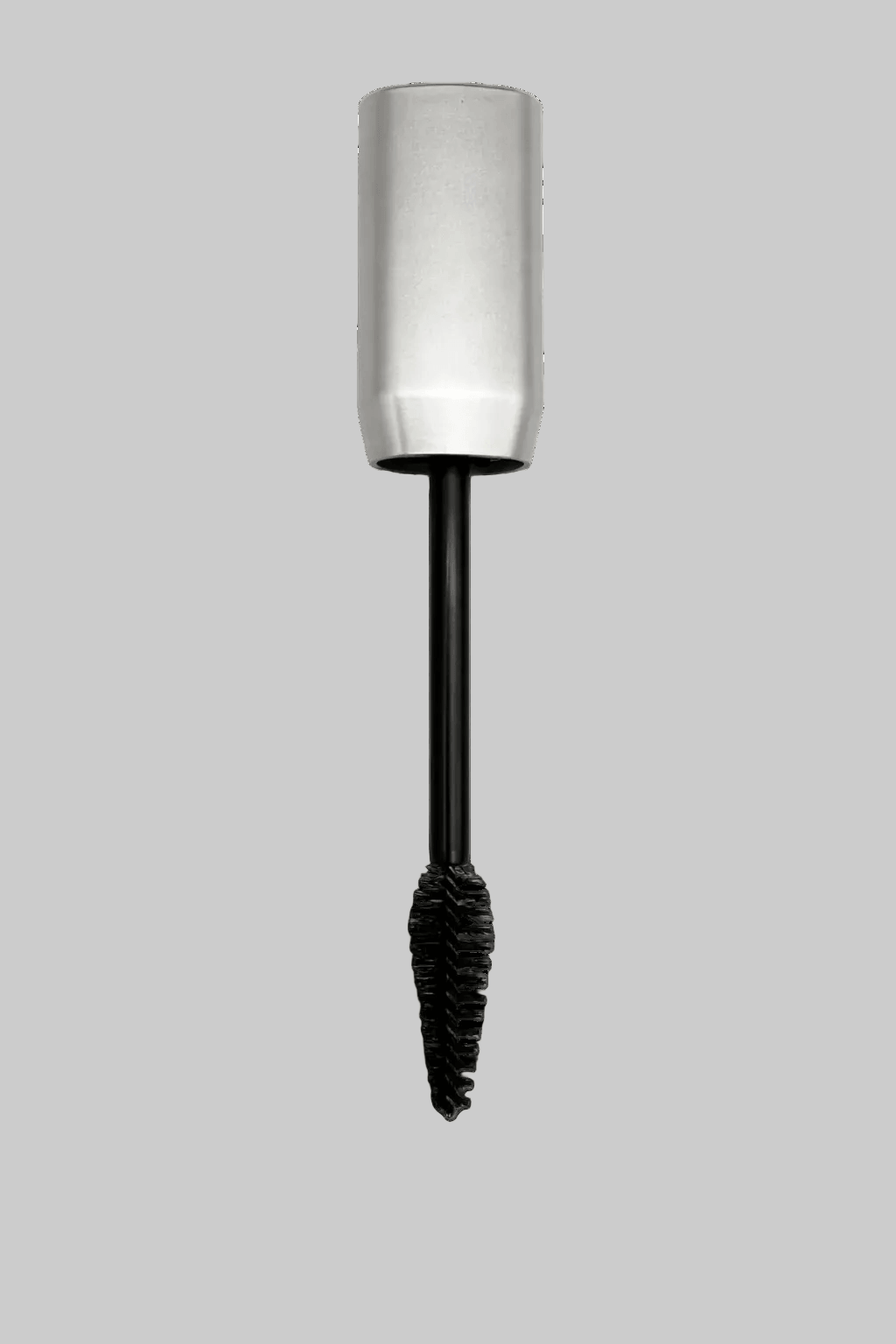 volumizing mascara with silver cap and black cilium on a gray background