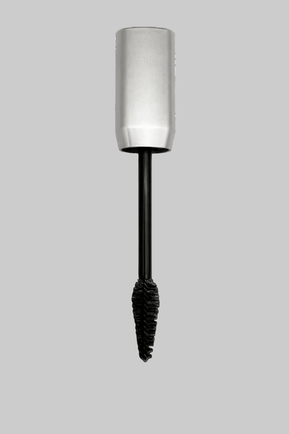 volumizing mascara with silver cap and black cilium on a gray background